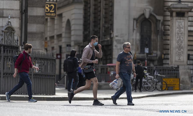 People walk on a street in central London, Britain, on Sept. 12, 2020. Almost 8 million Britons will be subjected to tighter lockdown restrictions next week after fresh measures were imposed in the West Midlands and Scotland, local media reported Saturday. A study by Imperial College London found that coronavirus cases in England were doubling every seven to eight days at the beginning of September. (Xinhua/Han Yan)
