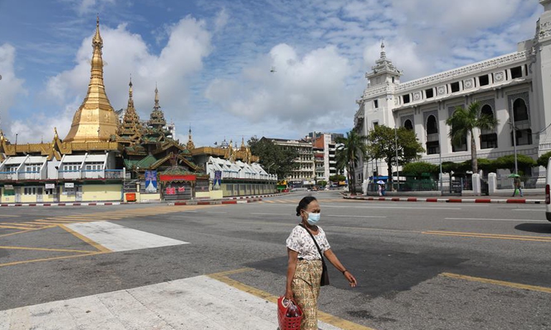 A woman wearing a mask walks in downtown Yangon, Myanmar, Sept. 26, 2020. The number of COVID-19 infection cases in Myanmar reached 9,991 on Saturday night, said a release from the Health and Sports Ministry. According to the release, Myanmar reported 880 new confirmed cases and 24 more deaths on Saturday night. (Xinhua/U Aung)