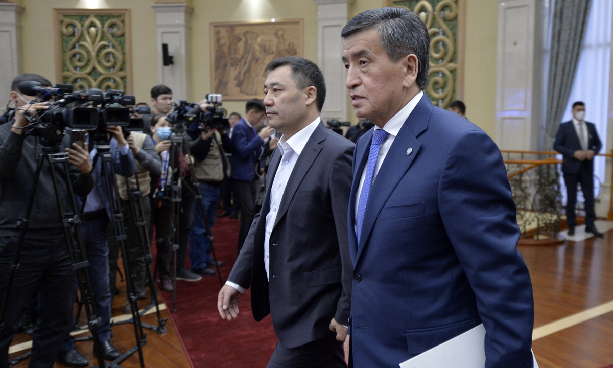 Kyrgyzstan’s President Sooronbai Jeenbekov (right) and Prime Minister Sadyr Zhaparov arrive for an official ceremony of a transfer of power at the Kyrgyzstan parliament in Bishkek on Friday. The nation called off a state of emergency the same day. Jeenbekov’s resignation comes after opposition groups last week seized government buildings in protest against the parliamentary election on October 4. Photo: AP