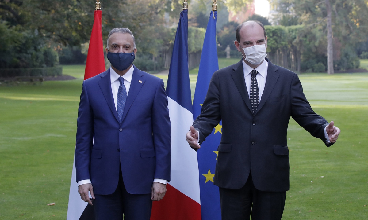 French Prime Minister Jean Castex (right) poses with Iraqi Prime Minister Mustafa al-Kadhimi before their talks on Monday in Paris. Mustafa al-Kadhimi will later meet with French President. The two sides will talk about issues including Iraq's economy, security and healthcare system. Photo: AFP