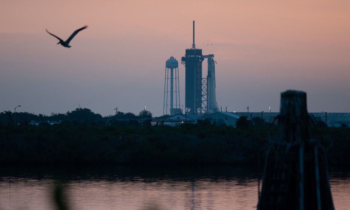 A SpaceX Falcon 9 rocket with Crew Dragon spacecraft onboard is seen on the launch pad at sunrise, at NASA's Kennedy Space Center in Florida, the United States, May 27, 2020. (Joel Kowsky/NASA/Handout via Xinhua)