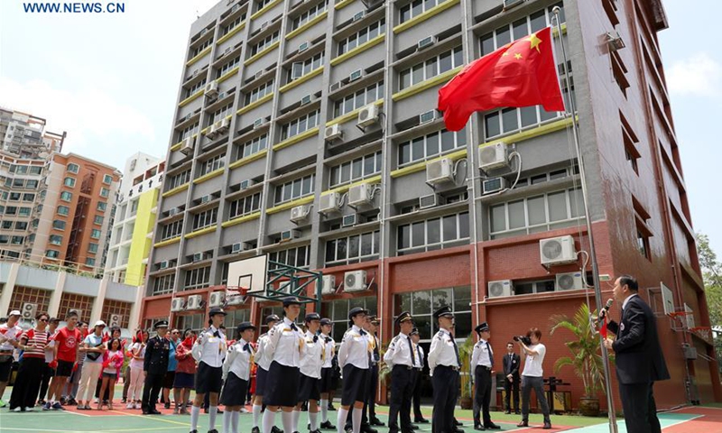 People attend a flag raising ceremony at a middle school in Yuen Long of New Territories, Hong Kong, south China, Aug. 11, 2019. The Association of Hong Kong Flag-guards held a flag raising ceremony at a middle school on Sunday. (Photo: Xinhua)