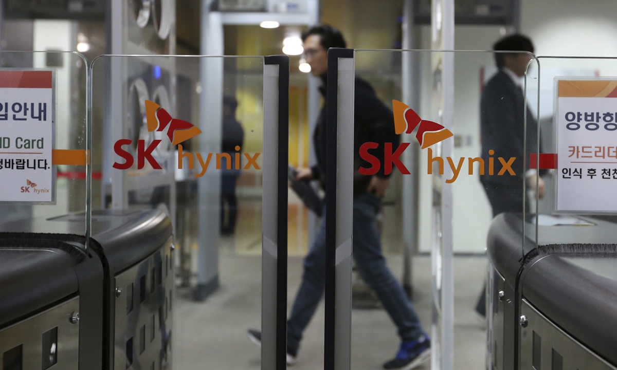 File photo: On April 23, 2018, people pass by the logos of SK Hynix Inc. at its office in Seongnam, South Korea.