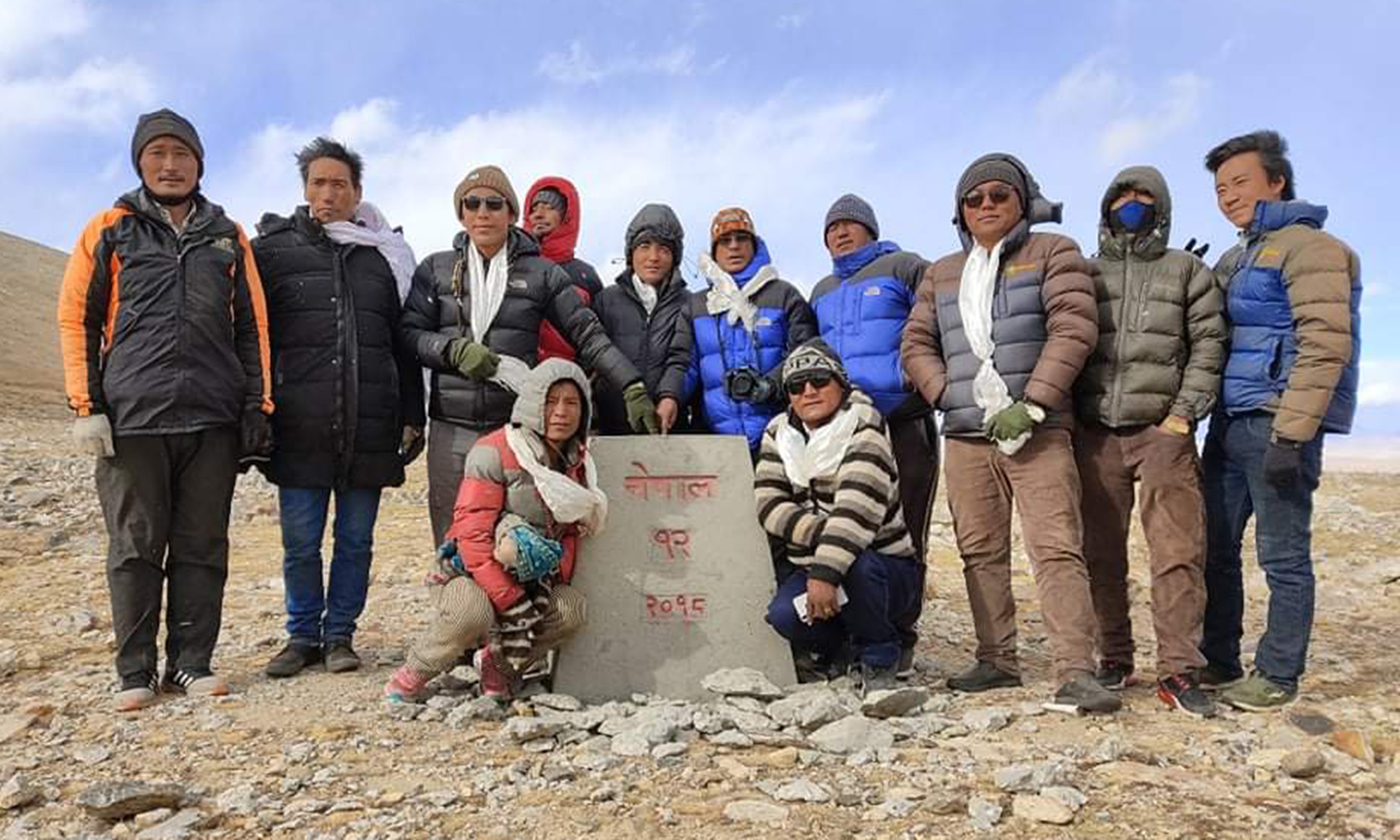 Karchen Lama (fifth from right) and his team visit the No.12 pillar at the China-Nepal border on November 4. Photo: Courtesy of Karchen Lama
