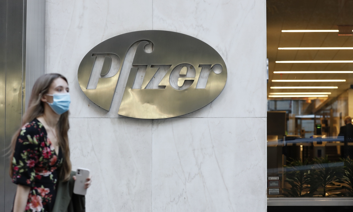 A pedestrian walks past a Pfizer outlet in New York. File photo: cnsphoto