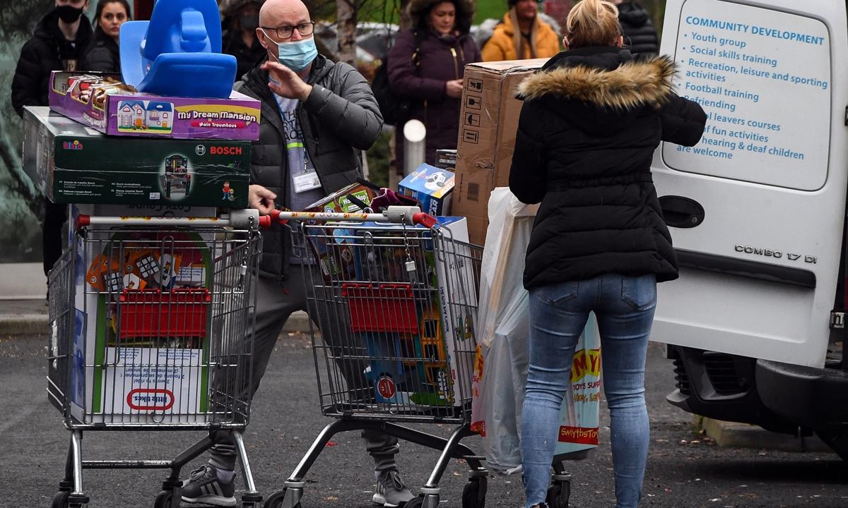 Shoppers leave a Smyths Toys shop in Glasgow ahead of the introduction of further coronavirus restrictions on Friday. Swathes of western and central Scotland prepared to enter a three-week period of restrictions. Photo: AFP