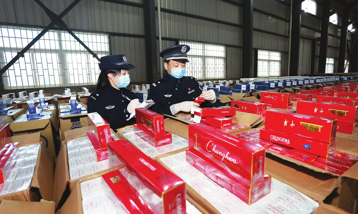 Police in Daishan county, East China's Zhejiang Province, count smuggled cigarettes on Wednesday. Local police, local customs and tobacco bureau solved a cigarette smuggling case, detained 29 suspects and seized 230,000 cartons of cigarettes worth 50 million yuan ($7.6 million). Photo: VCG