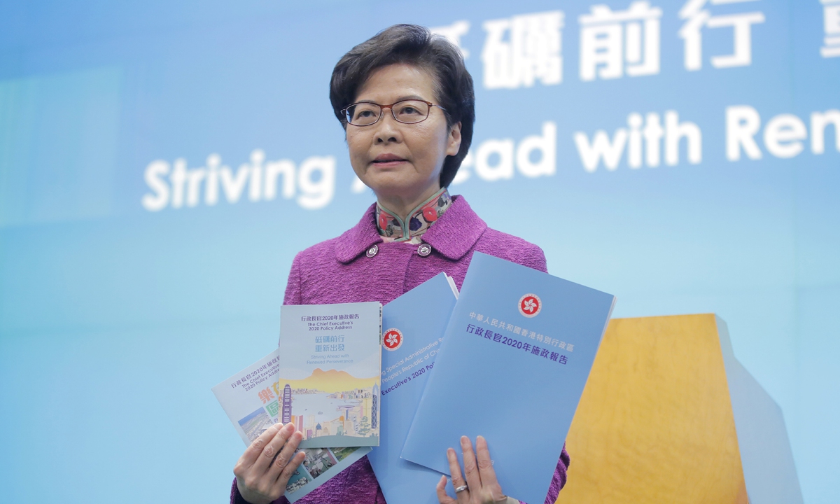 Hong Kong Chief Executive Carrie Lam poses with copies of her policy address at a news conference in Hong Kong on Wednesday. Lam lauded the city's new national security law on Wednesday as 