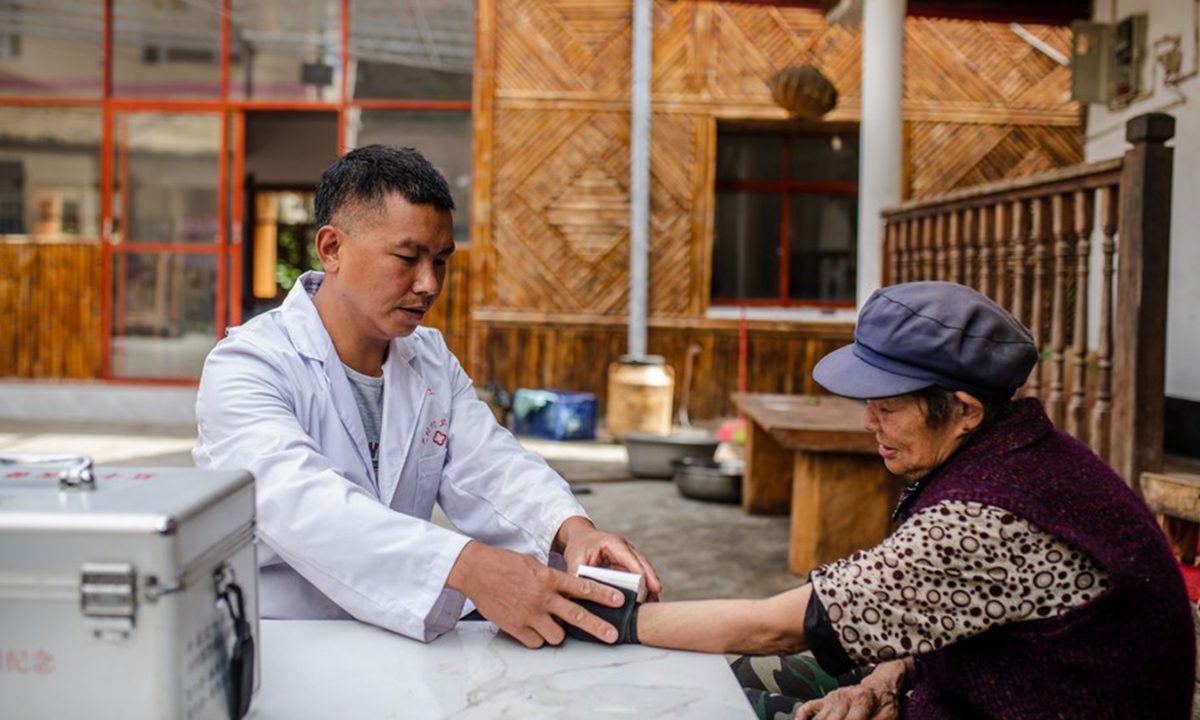 A rural doctor measures blood pressure for a villager of the Derung ethnic group at Bapo Village of Dulongjiang Township in Gongshan Derung and Nu Autonomous County, southwest China's Yunnan Province, Oct. 26, 2020. (Xinhua/Hu Chao)