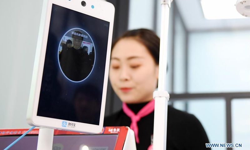 A customer uses a facial recognition payment equipment dubbed Dragonfly at a bakery shop in Beijing, capital of China, Dec 27, 2018.File photo:Xinhua
