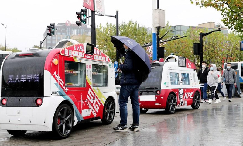 Unmanned catering cars park outside the subway station of Zhangjiang Jinke Road in Shanghai, east China, Nov. 26, 2020. Photo:Xinhua