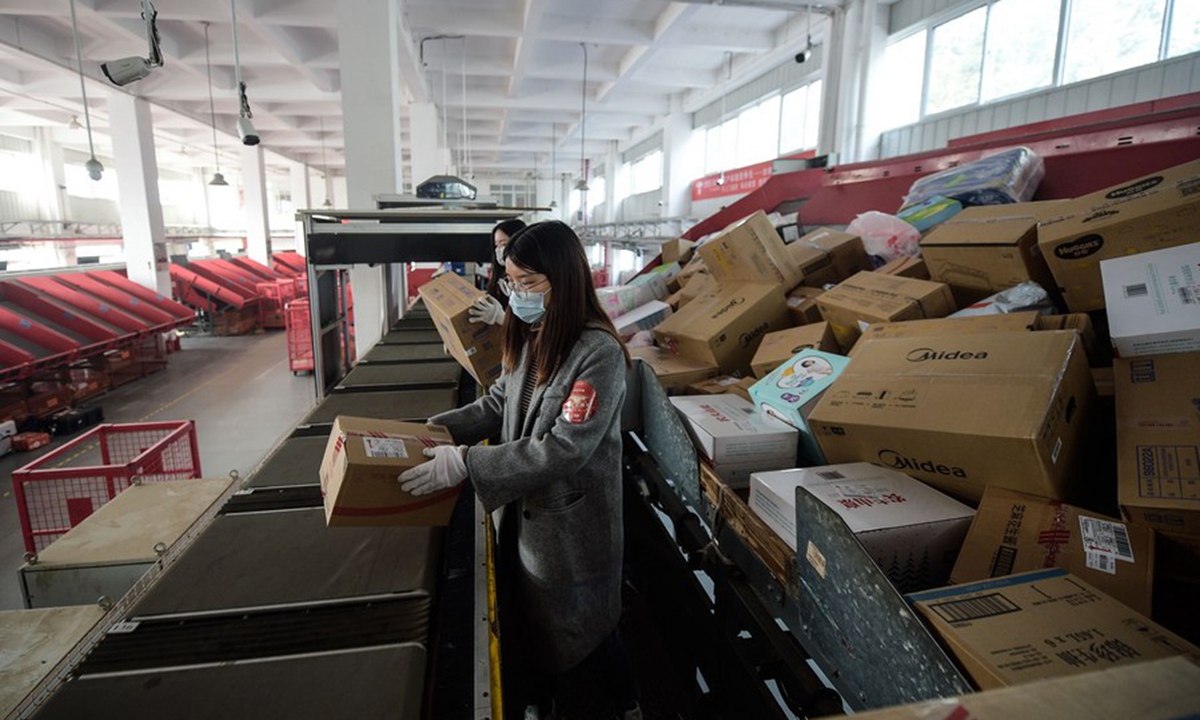 Staff members sort parcels at a distribution center of E-commerce giant JD.com in Beijing, capital of China, Nov. 11, 2020. (Xinhua/Peng Ziyang)