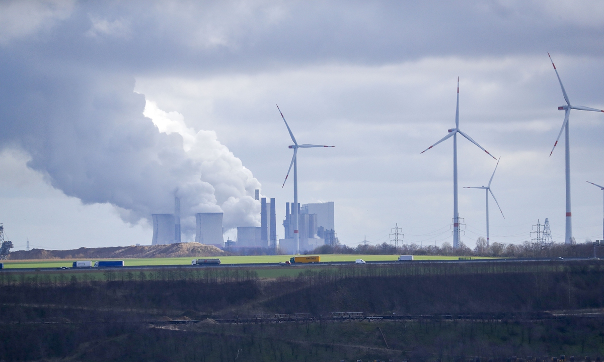 Wind turbines operate near the Neurath lignite fueled power station, operated by RWE AG, in Neurath, Germany on March 3. Photo: VCG