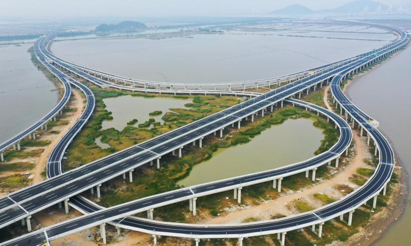 Aerial photo taken on Dec. 9, 2020 shows an interchange of Hezhou-Gaolan Port Highway on the Pearl River estuary in south China's Guangdong Province. Upon completion, the 35-km highway will be an important channel linking the west bank of the Pearl River estuary and the Guangdong-Hong Kong-Macao Greater Bay Area. (Xinhua/Liu Dawei)

