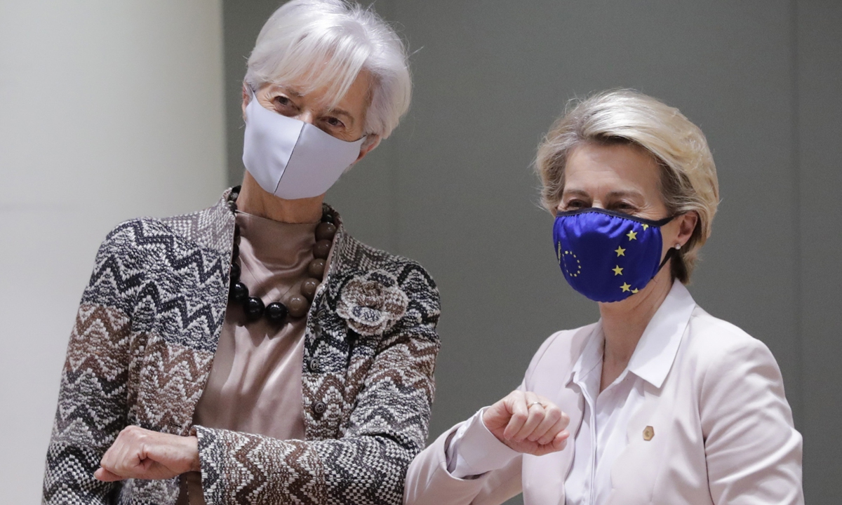 European Central Bank President Christine Lagarde (left) greets European Commission President Ursula von der Leyen with an elbow bump during a roundtable meeting at an EU summit in Brussels on Friday. European Union leaders have reached a deal to cut the bloc's greenhouse gas emissions by at least 55 percent by the end of the decade compared with 1990 levels, ahead of a UN Climate Ambition Summit on Saturday. Photo: AP