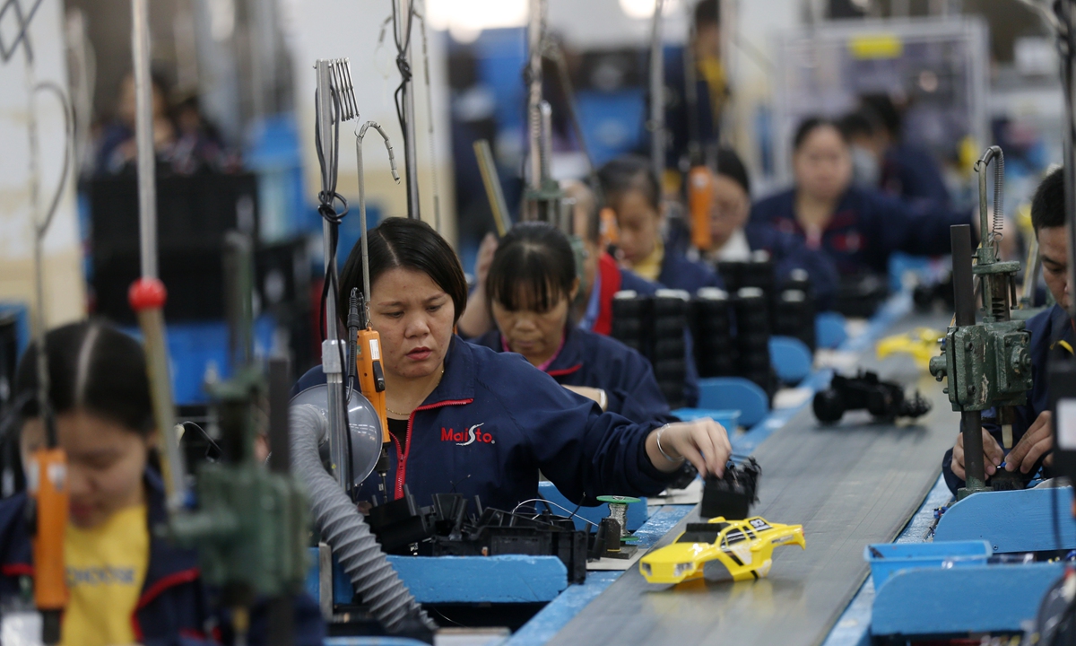 Workers assemble toy cars inside a factory in Dongguan, South China's Guangdong Province on December 16, 2020. Photos: Cui Meng/GT