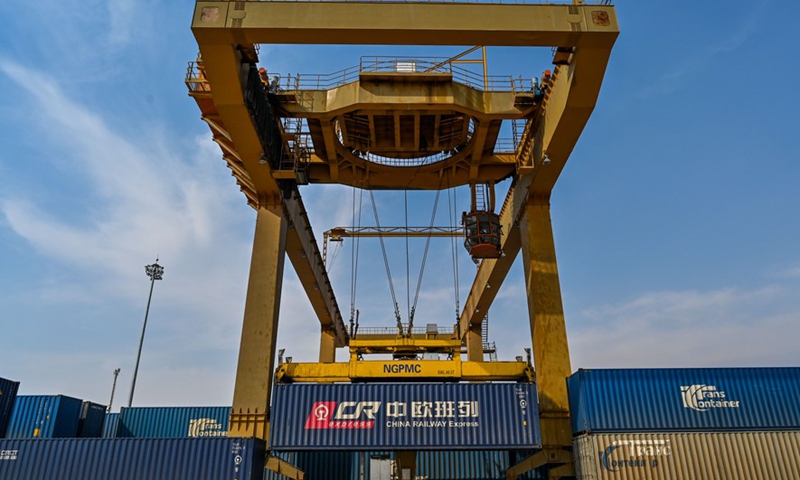 A crane loads containers at the Manzhouli Railway Station in Manzhouli, a land port on the China-Russia border, north China's Inner Mongolia Autonomous Region, April 13, 2020.Photo:Xinhua