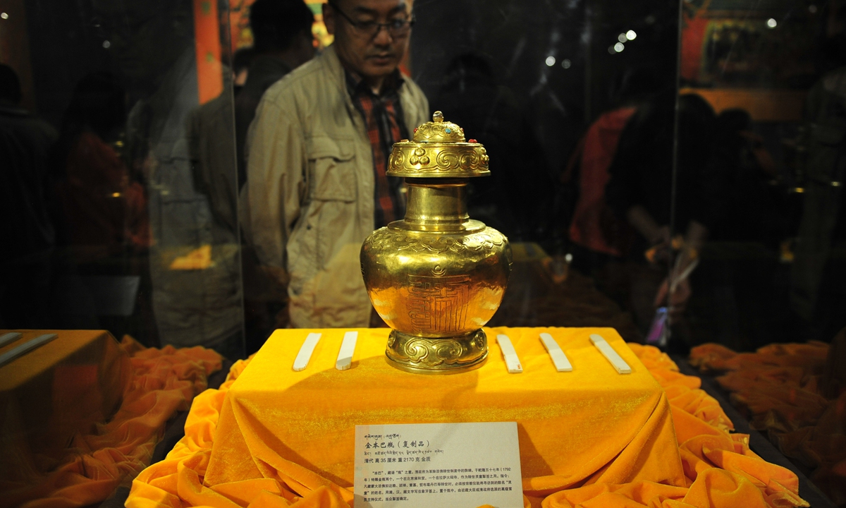 A replica of the golden urn and ivory slips bestowed by the Qianlong Emperor of the Qing Dynasty to the Eighth Dalai Lama is on display at a museum in Lhasa, Tibet Autonomous Region, August 11, 2014. Photo: cnsphoto