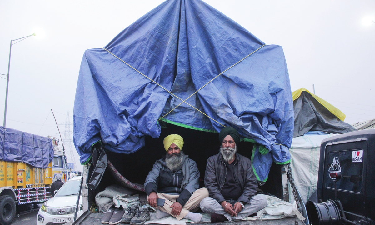 Farmers sit in a tractor-trolley on a blocked highway during a protest against the newly passed farm bills at Delhi-Uttar Pradesh border near Ghazipur on the outskirts of New Delhi, India on Saturday. Photo: AFP