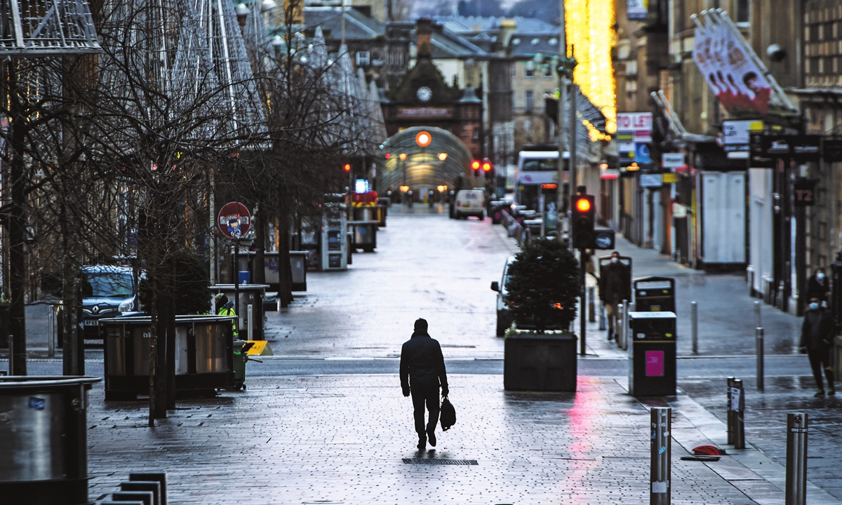 Pedestrians walk through central Glasgow as Britain enters a national lockdown in London on Tuesday. Scotland is to impose a nationwide coronavirus lockdown for the rest of January because of a surge in cases, First Minister Nicola Sturgeon announced. Photo: AFP