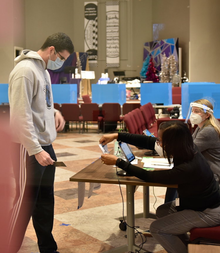 A voter checks in at the Neighborhood Church polling station in Candler Park, Atlanta, Georgia, during the Georgia Senate runoff elections on Monday. Photo: AFP