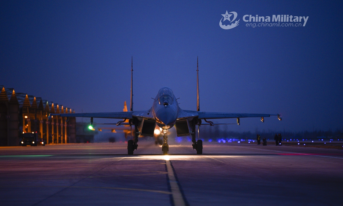 A fighter jet attached to an aviation regiment under the PLA Air Force taxies on the flightline before takeoff during a recent round-the-clock flight training exercise. (eng.chinamil.com.cn/Photo by Yuan Hua)