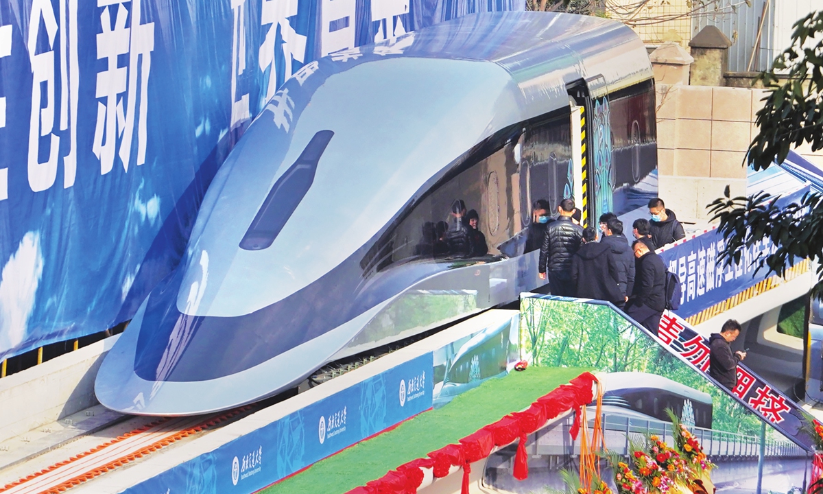 People visit a prototype of a domestically developed superconducting maglev train that rolled off the production line on Wednesday in Chengdu, Southwest China's Sichuan Province. The train, dubbed the 