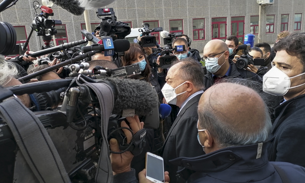 Italian anti-mafia prosecutor Nicola Gratteri (center) is surrounded by media as he arrives on Wednesday for the opening of the 
