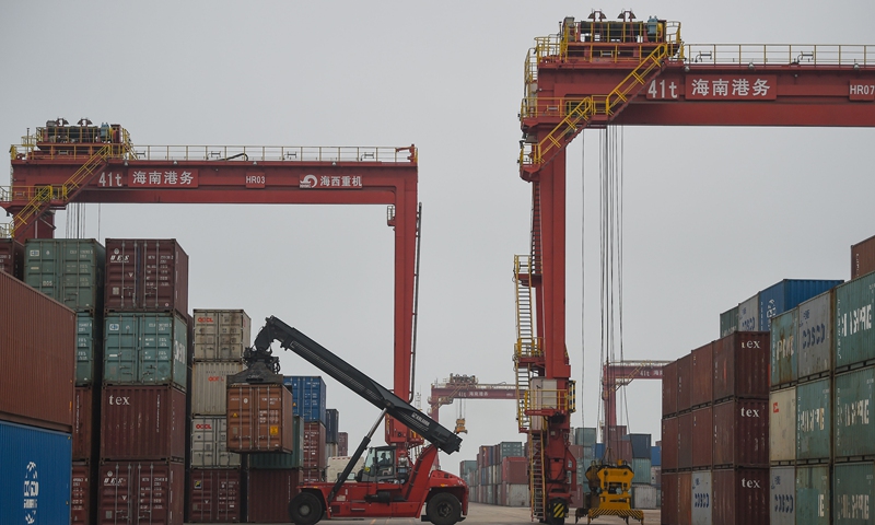 A worker loads containers at the port of Yangpu in south China's Hainan Province, April 8, 2020. (Xinhua/Pu Xiaoxu)