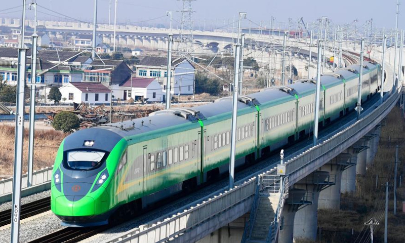 A train runs through Huangjing Township of Taicang, east China's Jiangsu Province, Jan. 19, 2021. China will implement a new railway operating plan starting Jan. 20, 2021, to further improve the country's railway passenger and freight transport capacity, according to the national railway operator. A total of 325 passenger trains, as well as 114 freight trains for major cargo transport lines, will be added under the new plan, said the China State Railway Group Co., Ltd.Photo:Xinhua