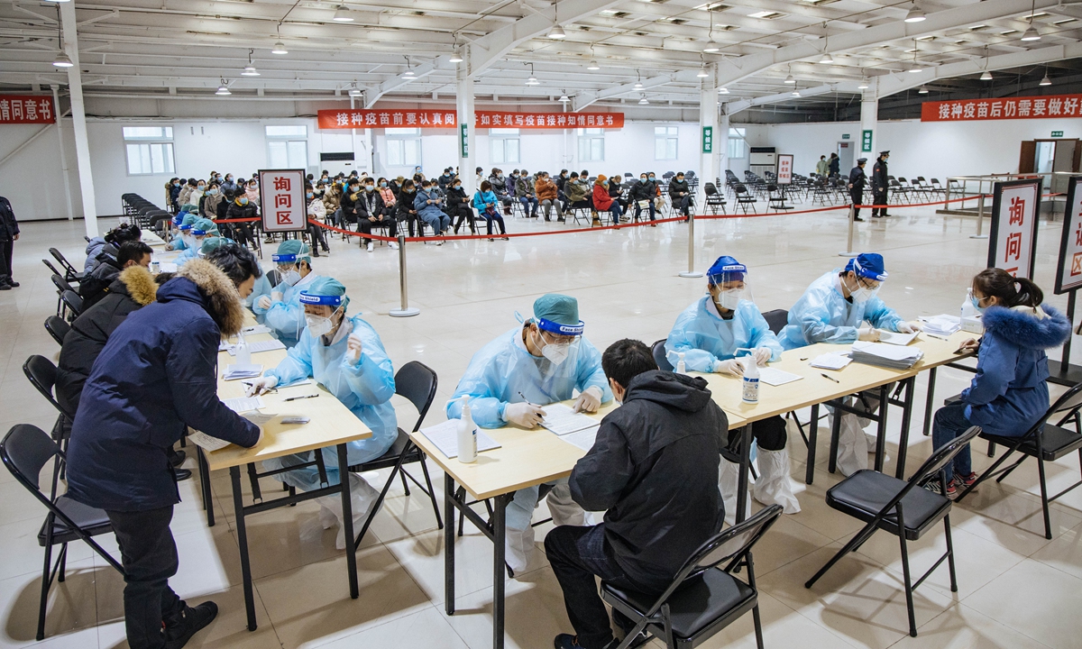 Doctors check information with people who are taking the second dose of the COVID-19 vaccine in Shijingshan district, Beijing on Monday. 
Photo: Li Hao/GT 