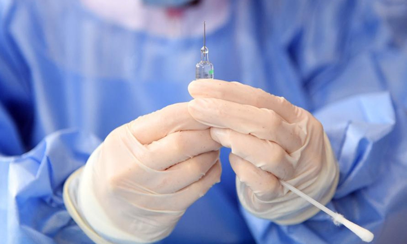 A medical worker (R) inoculates a recipient with a 2nd dose of COVID-19 vaccine at a temporary vaccination site in Haidian District of Beijing, capital of China, Jan. 29, 2021. The administration of the second dose of COVID-19 vaccines for key groups of residents throughout Beijing started on Jan. 22, and is expected to conclude before Feb. 8.Photo:Xinhua