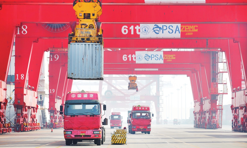 Trucks run through the container terminal of the Lianyungang port in East China’s Jiangsu Province on Wednesday. The port got off to a good start this year with its cargo throughput up 3.87 percent year-on-year to 22.06 million tons in January. Photo: cnsphoto