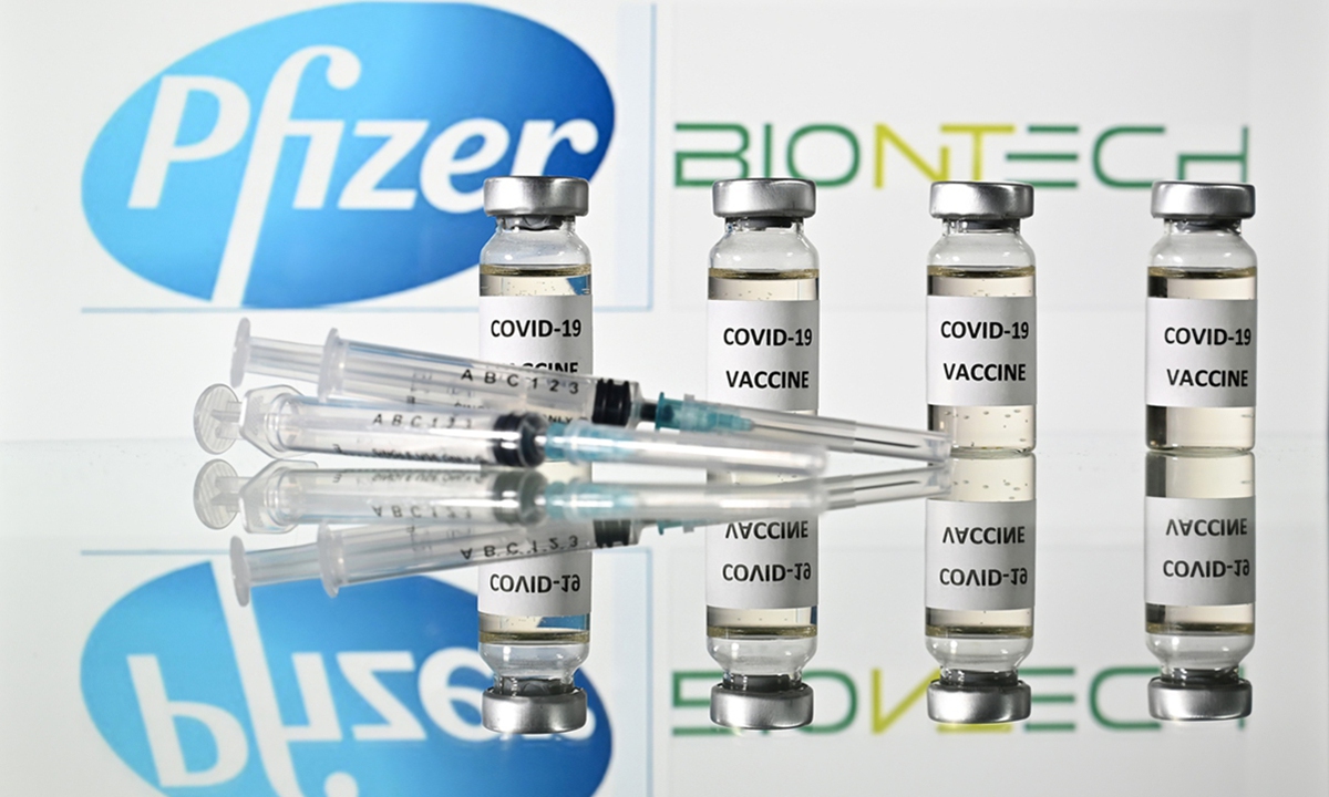 An illustration shows vials of a COVID-19 vaccine and syringes with the logos of US pharmaceutical company Pfizer and German partner BioNTech. Photo: AFP