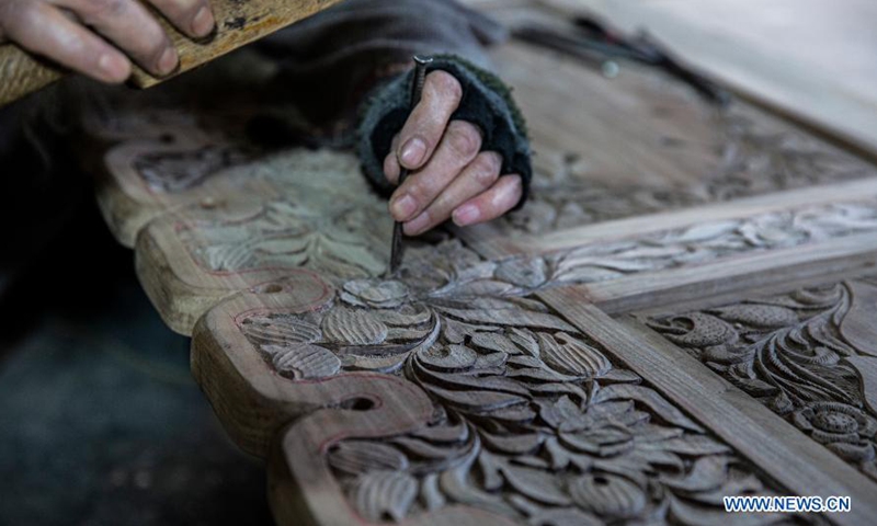 Wood carving work displayed at workshop in summer capital of Indian