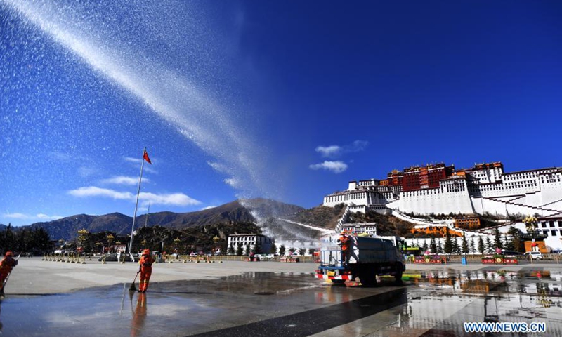 Sanitary workers clean the square of the Potala Palace in Lhasa, capital of southwest China's Tibet Autonomous Region, Feb. 8, 2021. Both the Spring Festival and the Tibetan New Year falls on Feb. 12 this year.Photo:Xinhua