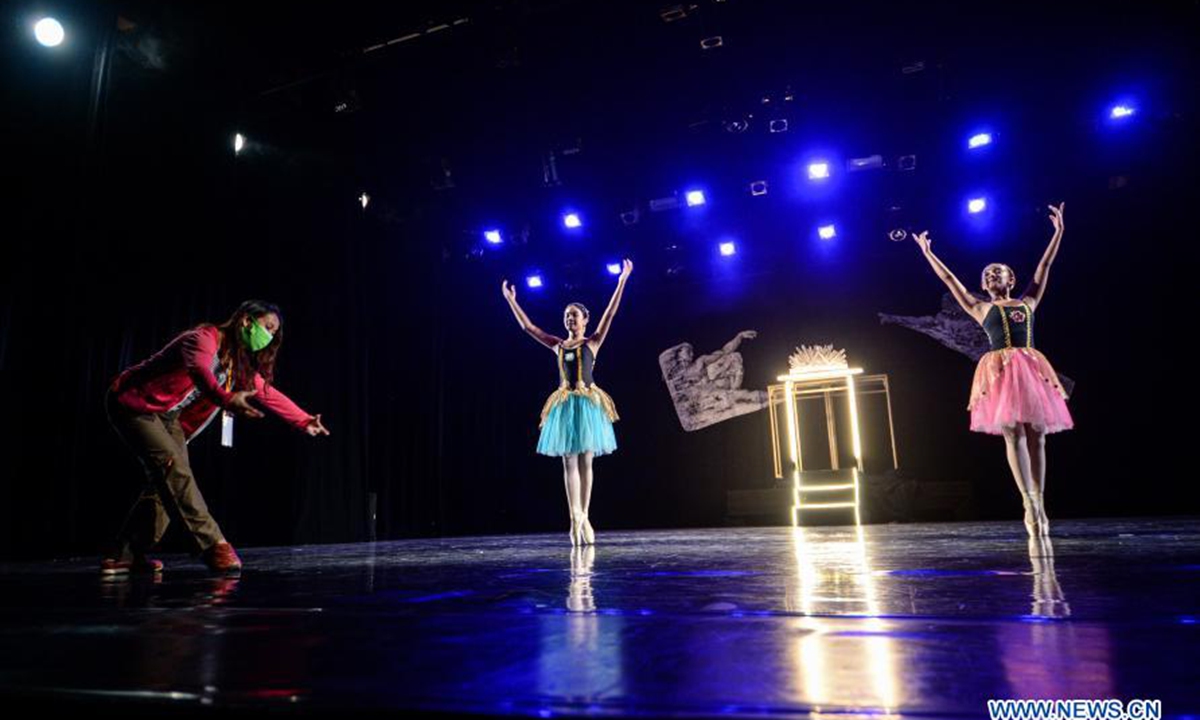 An instructor guides members of Namarina Youth Dance (NYD) during an rehearsal to the recording of virtual ballet performance The Story of Man: In Search of New Ideals amid COVID-19 pandemic at Gedung Kesenian Jakarta, in Jakarta, Indonesia, on Feb. 20, 2021. (Xinhua/Agung Kuncahya B.)