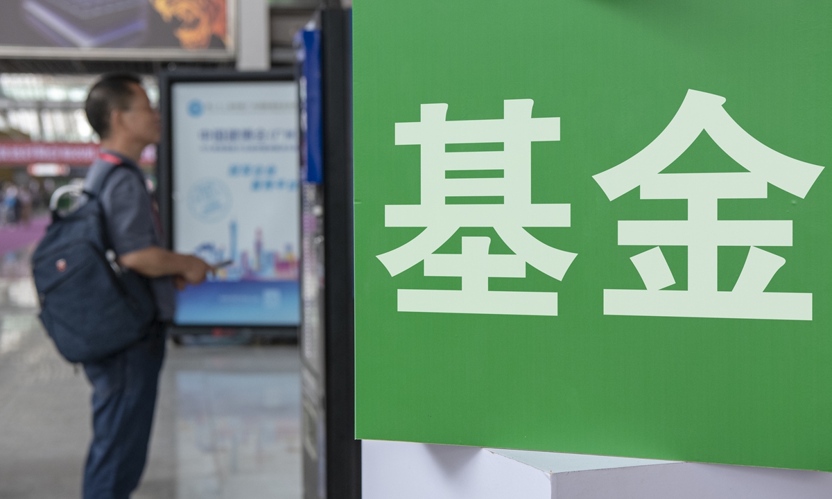 Creative photo shows a man standing in front of a green board that has the word of Fund. Photo: IC  