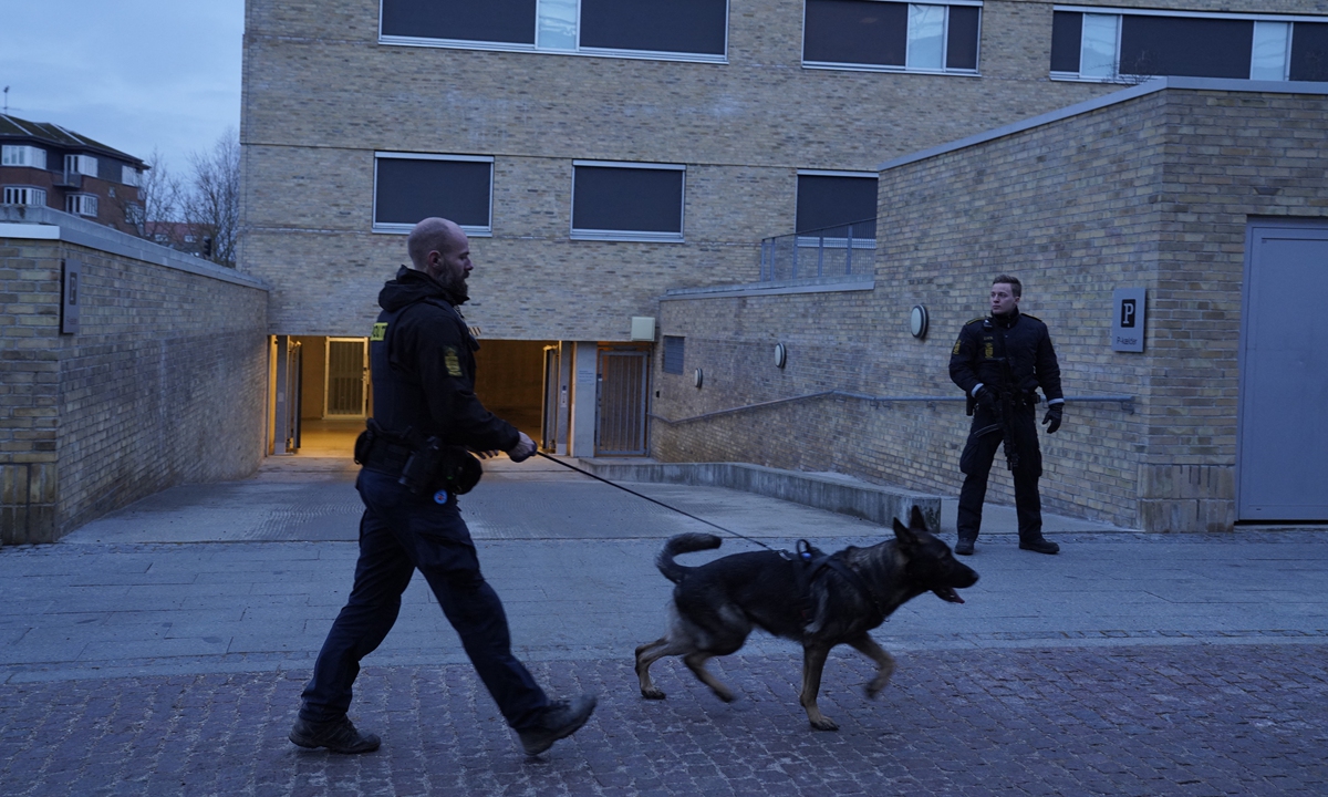 Police officers stand guard in front of the court building in Holbaek, Denmark on Tuesday as the custody period of six people suspected in a terrorist case has expired. Photo: AFP