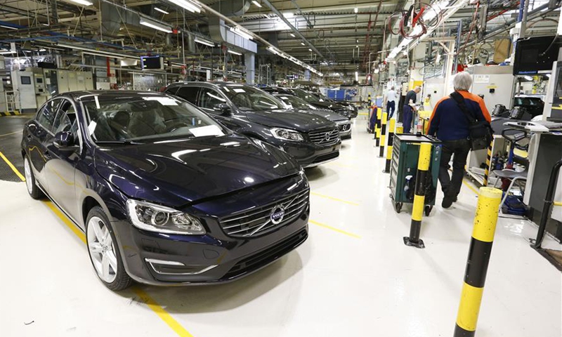 File photo taken on May 24, 2017 shows a worker walks past newly-assembled cars at the Volvo Car Gent in Ghent, Belgium. Volvo Car Gent, the second largest Volvo assembly line except that in Sweden, was purchased by the Chinese car manufacturer Geely Holding Group in 2010.Photo:Xinhua