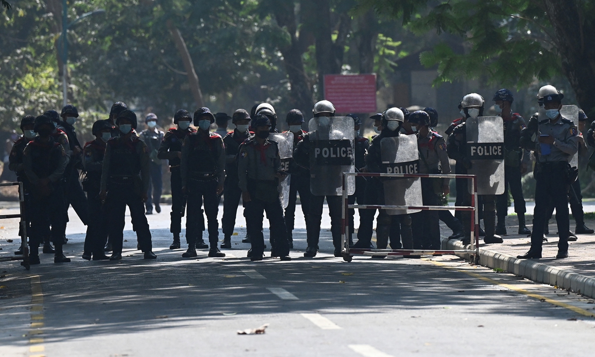 Police block a road during a protest at the Yangon University compound amid a demonstration against the military coup in Yangon, Myanmar on Thursday. Photo: AFP