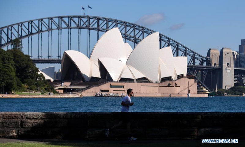 A man runs in a park opposite the Sydney Opera House in Sydney, Australia, on Feb. 26, 2021. Restrictions in the Australian state of New South Wales (NSW) will further ease from Friday as vaccination rolled out and no local case status continued. (Xinhua/Bai Xuefei)