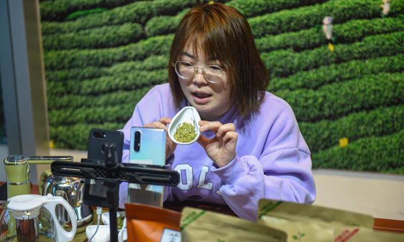 Ye Yuzhu introduces tea to the audience via livestreaming at the tea market in Songyang County of Lishui City, east China's Zhejiang Province, Feb. 25, 2021. The tea market in Songyang County, as a major market of green tea in China, sees the daily tea trade value of about 20 million yuan (3.1 million U.S. dollars).Photo:Xinhua