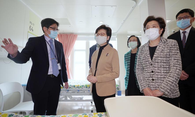 Carrie Lam (2nd L), Chief Executive of the Hong Kong Special Administrative Region (HKSAR), Qiu Hong (2nd R), deputy head of the Liaison Office of the Central People's Government in the HKSAR and other guests visit a ward of the North Lantau Hospital Hong Kong Infection Control Center (HKICC) in south China's Hong Kong, Feb. 25, 2021.