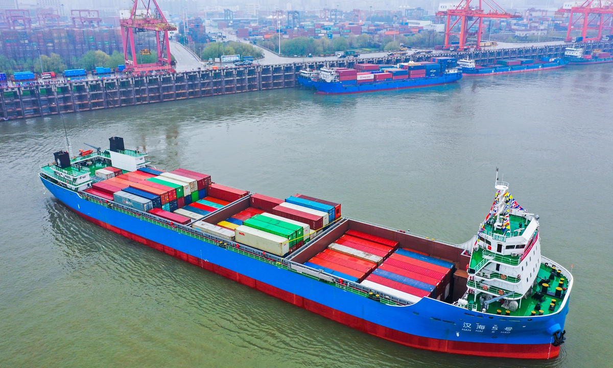 A container vessel sails away from the Port of Wuhan, Central China’s Hubei Province bound for Shanghai along the Yangtze River. The ship is loaded with medical supplies, machinery equipment, flat glass, optic fibers and tea slated for export markets. The vessel is one of the most advanced linking the central China river port with the sea, as China develops the Yangtze River economic belt that accounts for 46.6 percent of the nation’s economic output. Photo: VCG