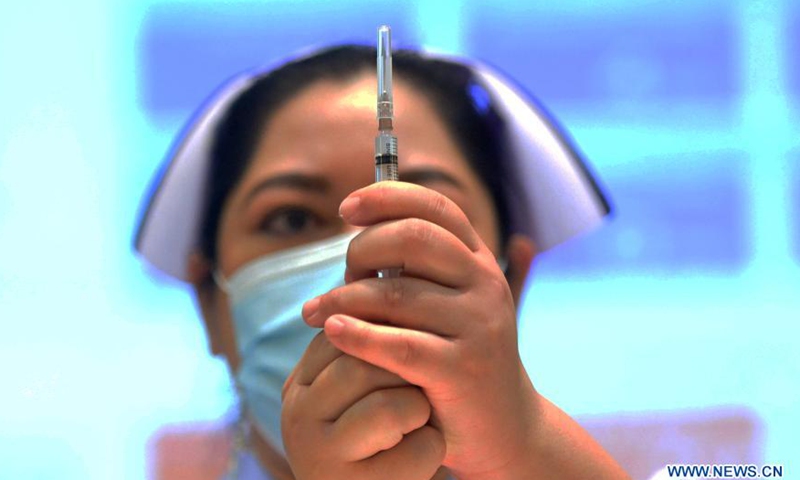 A nurse prepares a dose of COVID-19 vaccine from China's Sinovac in Bangkok, Thailand, Feb. 28, 2021. Thailand on Sunday started its COVID-19 vaccination roll-out, with the first shot, using China's Sinovac vaccine, going to Deputy Prime Minister and Public Health Minister Anutin Charnvirakul.Photo:Xinhua