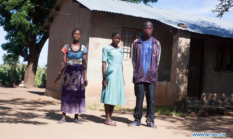 A farmer family pose for a photo in Chikwawa, Malawi, on Feb. 25, 2021. Cotton production in Malawi has gone down with the effects of COVID-19. According to experts, over 10,000 farmers in Malawi have abandoned cotton production this year due to lack of loans and last year's poor market prices influenced by COVID-19.(Photo: Xinhua)