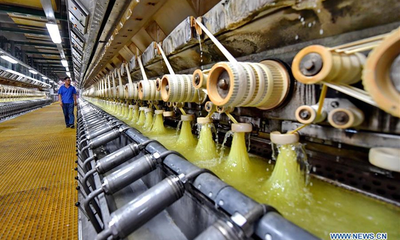 An employee works on a production line of viscose staple fiber in Tangshan Sanyou Group in Tangshan, north China's Hebei Province, July 12, 2018. A viscose staple fiber plant of Sanyou Group, a key project of Hebei Province, has been put into operation recently. With a 200,000-ton annual production, this project enables a total annual production capacity of chemical fiber of 800,000 tons for the company.(Photo: Xinhua)