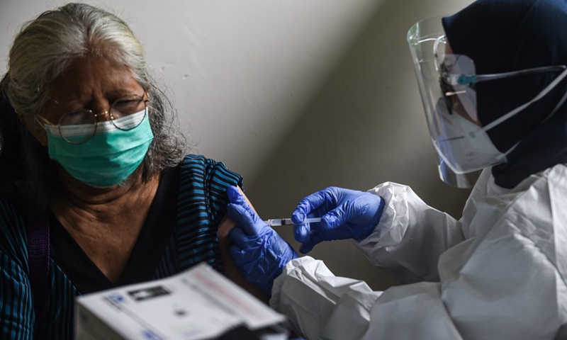 A woman receives a dose of COVID-19 vaccine during a mass vaccination campaign in Jakarta, Indonesia, Feb. 24, 2021. (Photo: Xinhua)