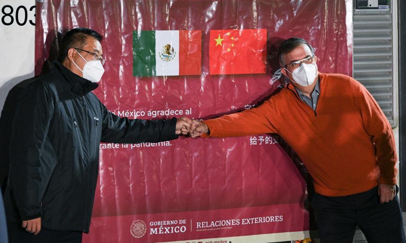 Mexican Foreign Minister Marcelo Ebrard (R) and Chinese Ambassador to Mexico Zhu Qingqiao pose for a photo in front of a temperature-controlled cargo container with COVID-19 vaccines from Chinese company Sinovac at Mexico International Airport in Mexico City, Mexico, Feb. 27, 2021. The second shipment of COVID-19 vaccines from Chinese company Sinovac arrived in Mexico City on Saturday.Photo:Xinhua